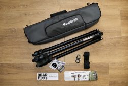 a camera and a tripod sitting on a wooden floor.