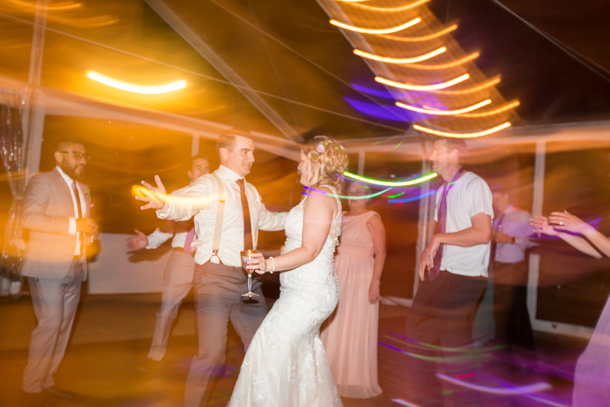 A bride and groom dancing at a wedding reception.