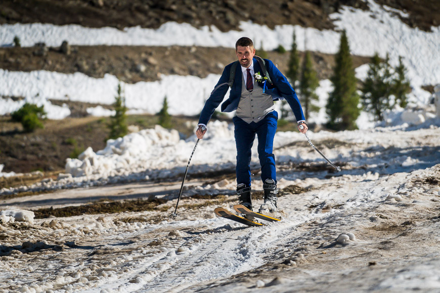 A man on skis on a snowy trail.