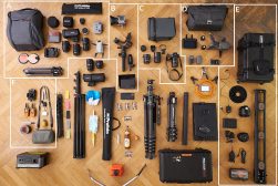 a list of camera equipment laid out on a floor.