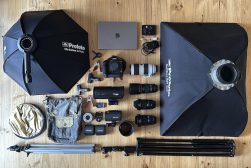 a bunch of camera equipment that are laying out on a table.
