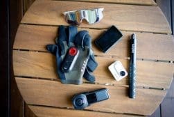 A group of cycling cameras on a wooden table.
