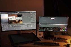 A desk with two monitors and a mouse.