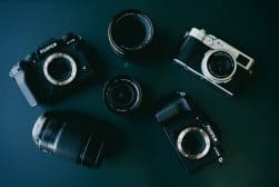 A group of cameras arranged on a dark surface.