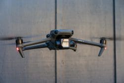 A black dji mavic flying in the air.