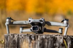 A dji mavic pro sits on top of a tree stump.