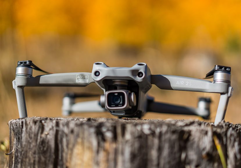 A dji mavic pro sits on top of a tree stump. A dji mavic pro sits on top of a tree stump.