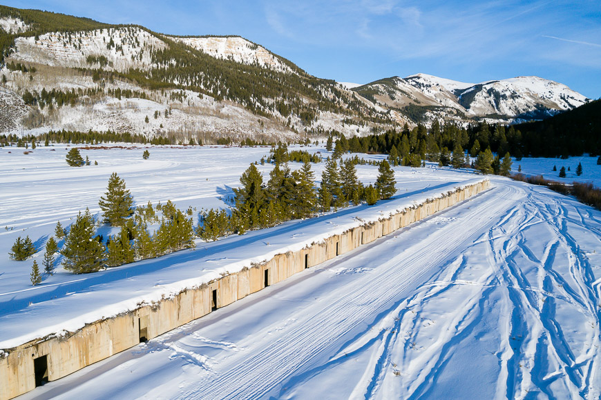 A snow covered road in the mountains.