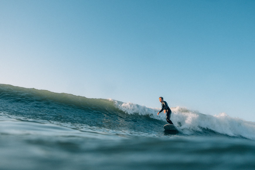 A man riding a wave on a surfboard.