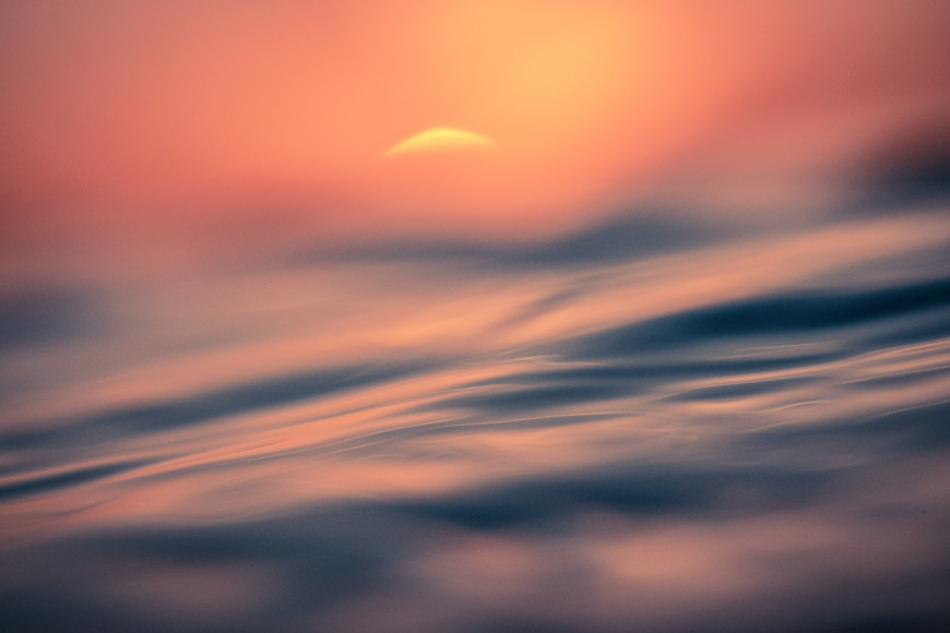 A blurry image of a sunset over water.