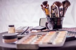 Makeup brushes and cosmetics on a table.
