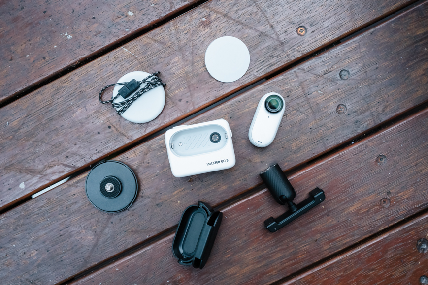 A group of small electronic devices on a wooden table.