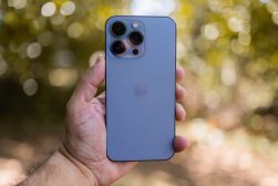 a person holding a blue iphone in their hand.