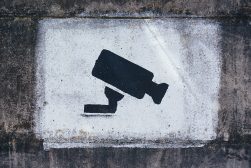 A cctv camera on a concrete wall.