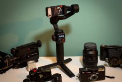A group of cameras, tripods, and other equipment on a table.