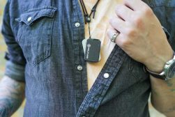 a man in a denim shirt with a Hollyland Lark Max lav mic
