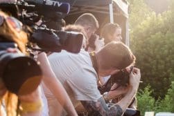 A group of people taking pictures at an outdoor event.