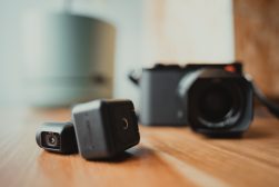 two cameras on a table next to each other.