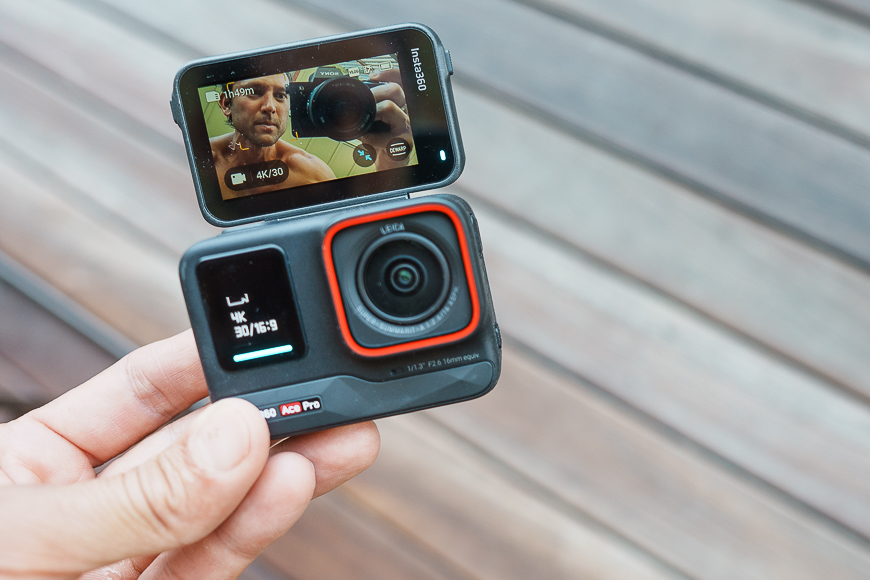 A person holding up a gopro action camera.