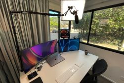 a desk with a computer and a laptop on it.