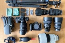 A collection of camera equipment laid out on a table.