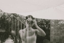 A woman is taking a picture of herself in a mirror.