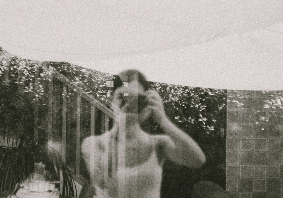 A woman is taking a picture of herself in a mirror. A woman is taking a picture of herself in a mirror.