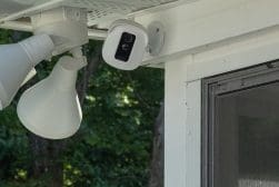 A security camera mounted on the side of a house.