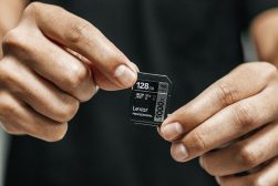 a person holding a small micro sd card.