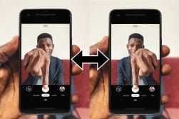 A person is holding a phone with a picture of a man on it.