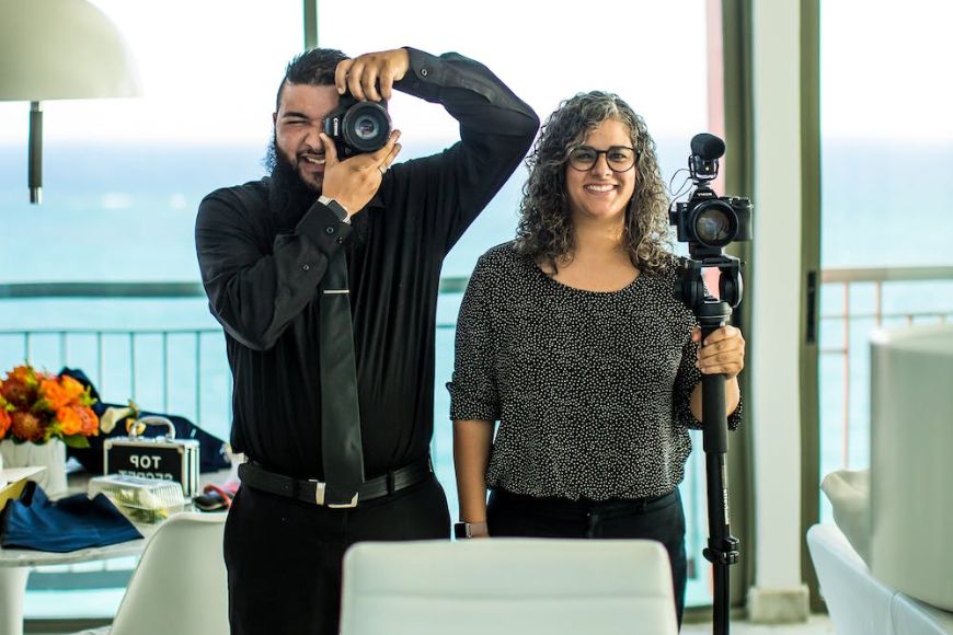 A man and woman taking a picture with a camera.