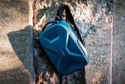 a blue bag sitting on top of a stone wall.