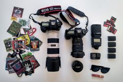 a white table topped with lots of different types of camera equipment.