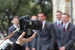 A group of groomsmen with a camera in front of them.