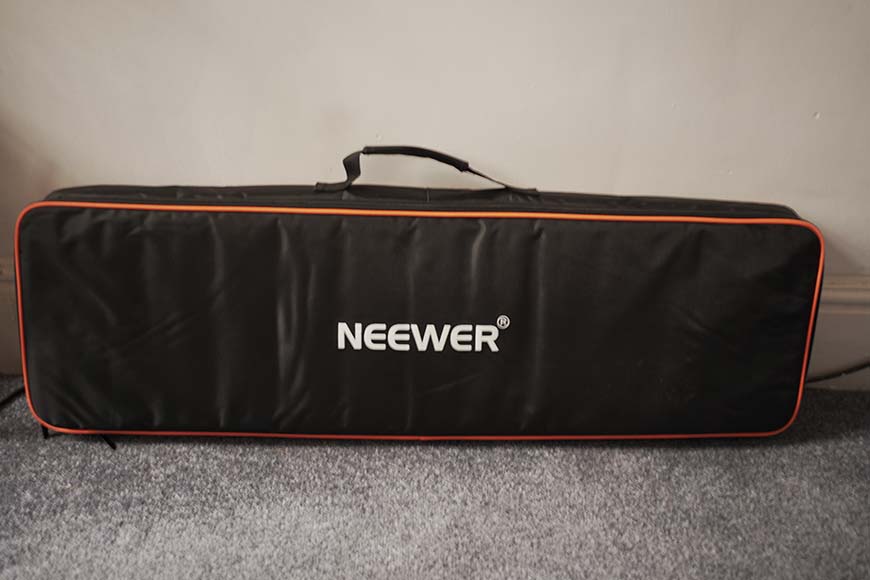 A black and orange bag with the word neever on it.