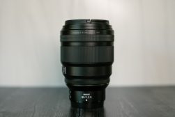 a camera lens sitting on top of a wooden table.