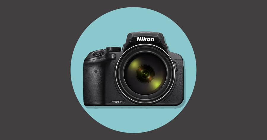 a black camera with a green lens.