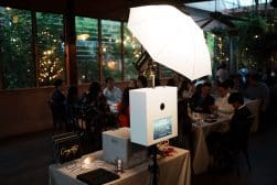 A white umbrella on a table in a dining room.