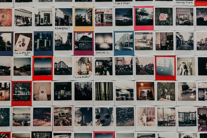 A wall of polaroid photos on a wall.