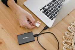 A person using a samsung external hard drive on a laptop.