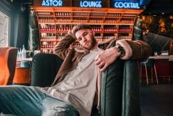 A man sitting on a couch in a bar.