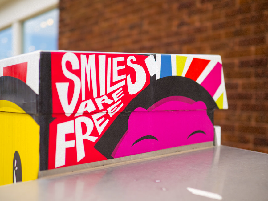 A box with a smiley face painted on it.