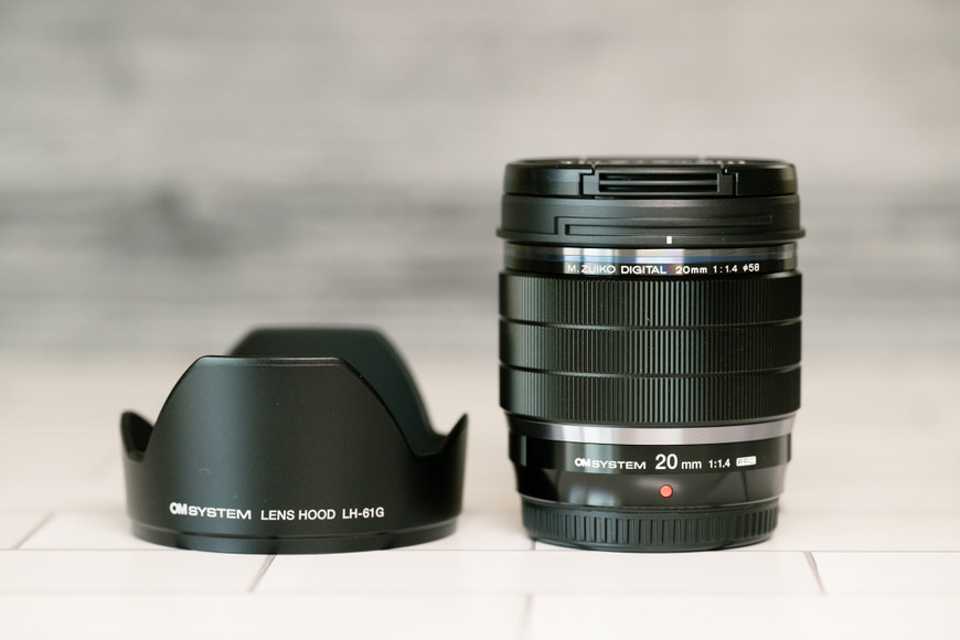 The OM System 20mm f/1.4 Pro Lens with lens hood.
