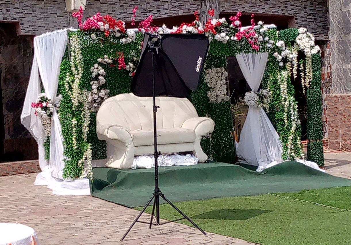 A wedding stage set up with flowers and a chair. A wedding stage set up with flowers and a chair.