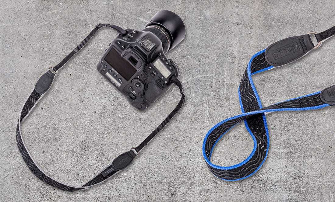cameras and straps on grey table