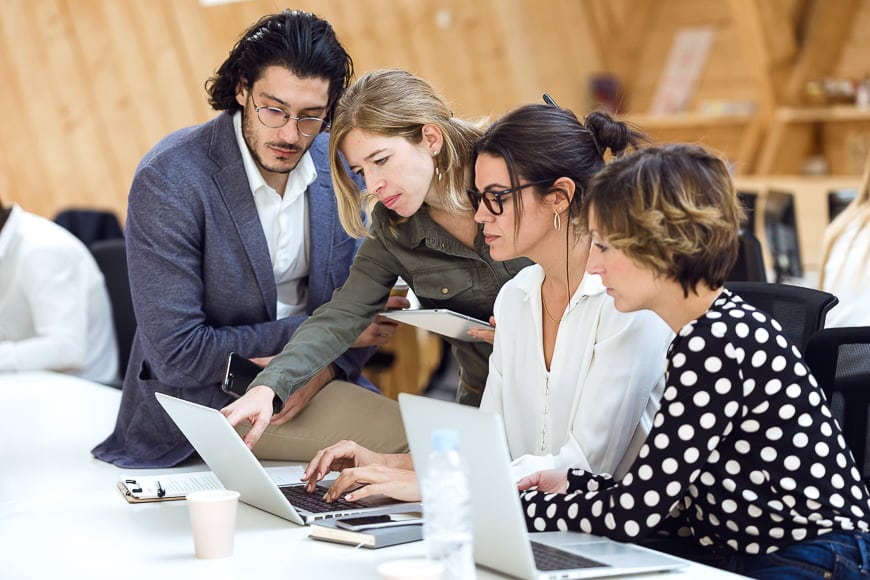 Businesspeople at a laptop.