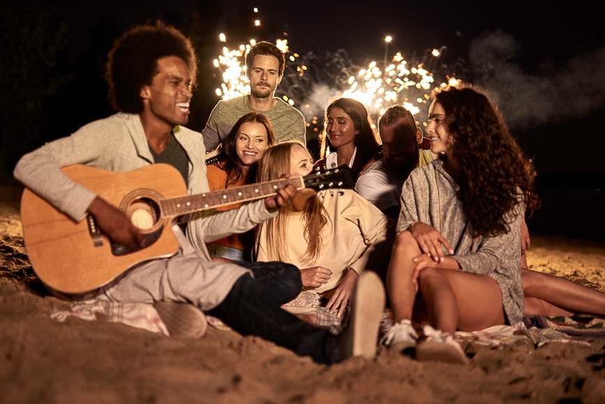 People singing on beach.