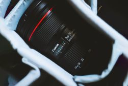 a close up of a canon usm camera lens in a bag.