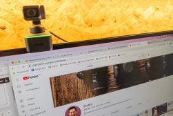 a computer screen showing YouTube with a webcam attached to it.